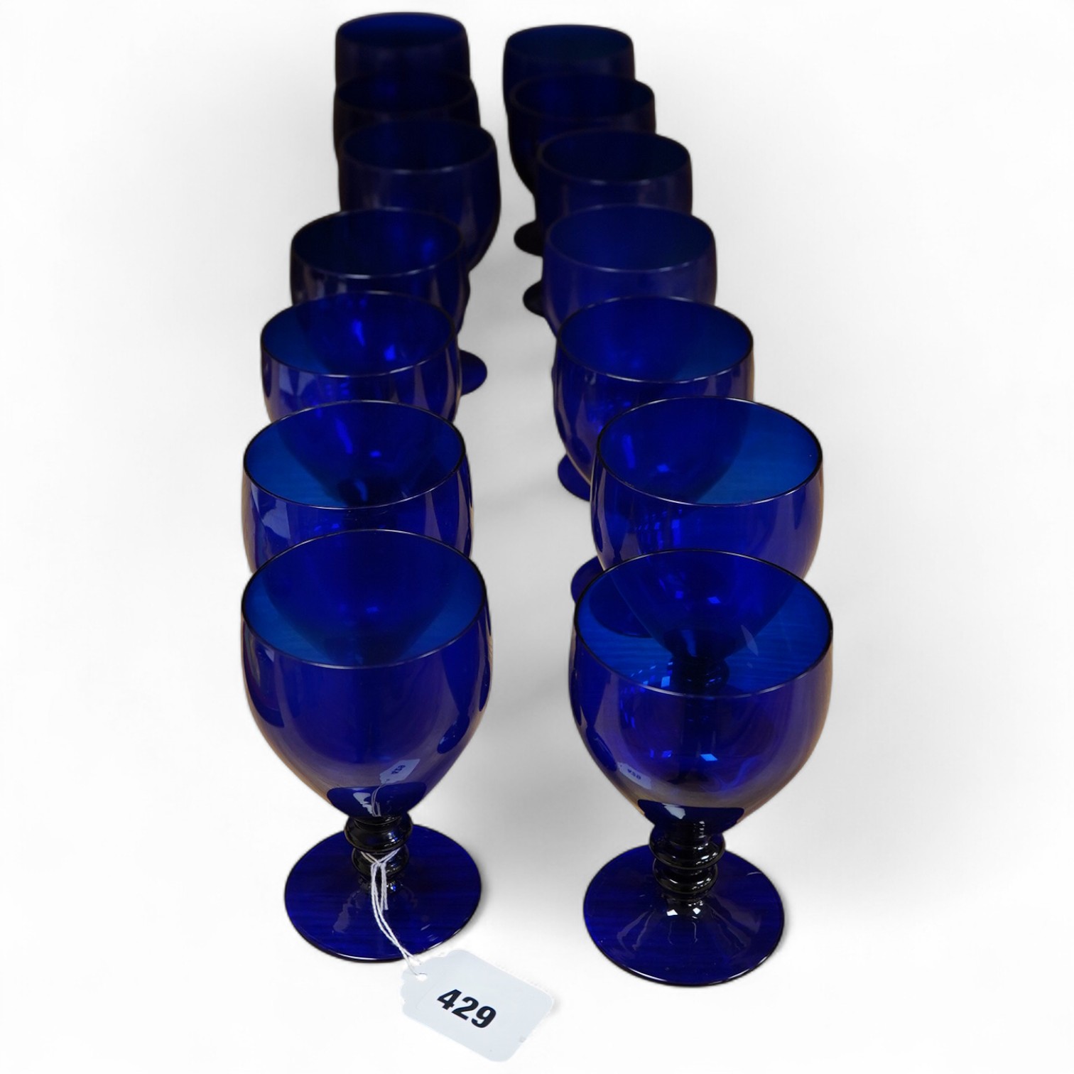A collection of fourteen Bristol blue glass rummers, largest 15cm high